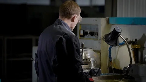 Young man in uniform standing in workshop Stock Footage 95018102