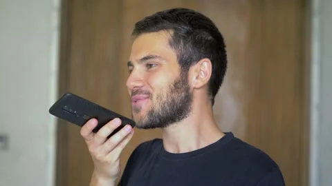 Young man use ai vocal assistant by smartphone to send a message Stock Footage 197471504