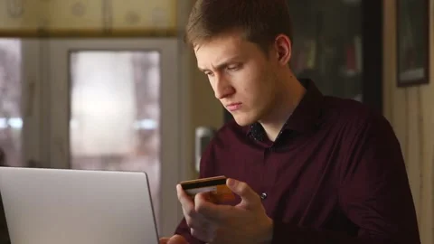 Young man use a computer for online purchases with a credit card. slow motion Stock Footage 148188582