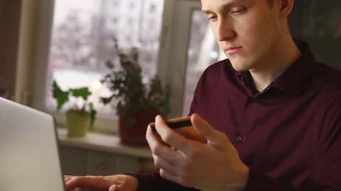Young man use a computer for online purchases with a credit card. slow motion Stock Footage 148188769