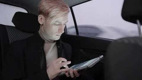 Young man use graphic tablet in a taxi Stockbeeldmateriaal 194141469