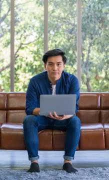 The young man use laptop computer to search for jobs. Stock Photos