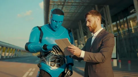 Young man use tablet computer talking with humanoid robot shows the way digital Stock Footage 133298197