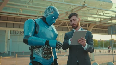 Young man use tablet computer shows the way talking with humanoid robot digital Stock Footage 133300527
