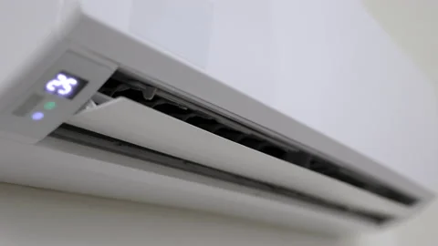  The young man used remote turn on the air conditioning . Adjust the temperature Stock-Footage 153969922