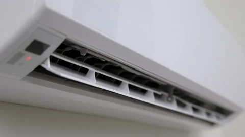 A young man used a remote to turn off the air conditioner. In the living room at Stock Footage 153969994