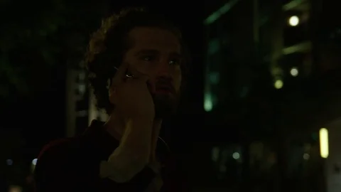 Young Man Uses Cell Phone at Night 스톡 동영상 77205912