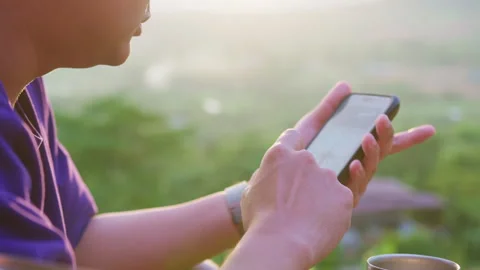 Young man uses his smartphone for browsing and online communication Stock Footage 342620240
