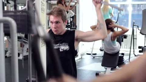Young Man Uses Lat Machine (training apparatus) Stock Footage 44385798