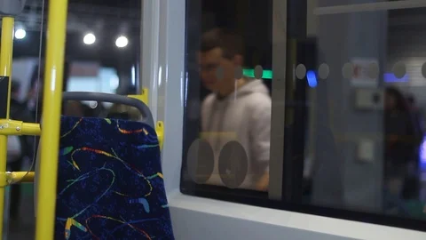 Young man uses a smartphone gadget on the bus Stock Footage 87136334