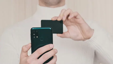 Young Man uses Smartphone to Scan QR Code on Cold Crypto Wallet for Transaction Video stock 200993727