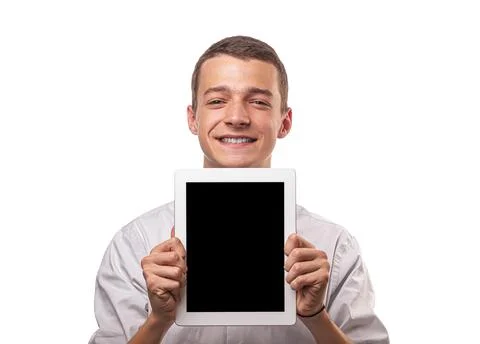 Young man uses a tablet computer. Isolated on a white background. Stock Photos