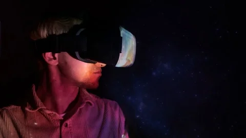 A young man uses VR-headset display and headphones for virtual reality game Video stock 101832977