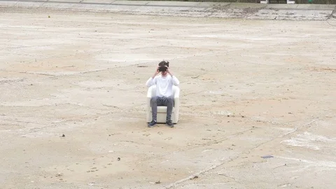 Young man using 360 virtual reality glasses and looking around outdoor Stock Footage 71488612
