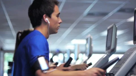 Young Man Using Aerobic Exercise Machine Stock Footage 6986024