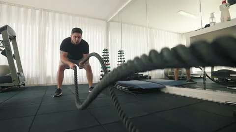 Young man Using Battle Ropes For fast pa... | Stock Video | Pond5