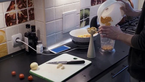 Young man using blender in the kitchen and using green screen smartphone Stock Footage 74159845