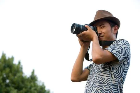 Young man using camera Stock Photos