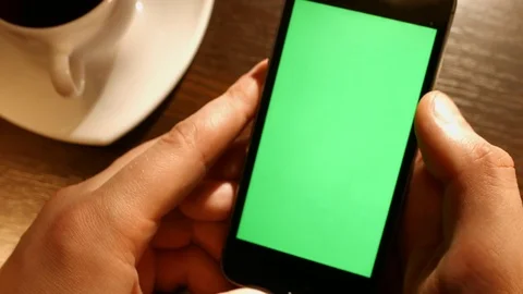 Young man using cell phone with green isolated touch screen. Video stock 72209676