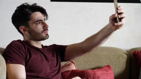 Young man using cell phone to take selfie photo Stock Photos