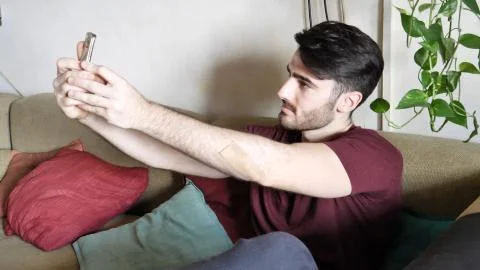 Young man using cell phone to take selfie photo Stock Photos