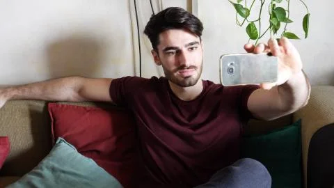 Young man using cell phone to take selfie photo Stock Photos