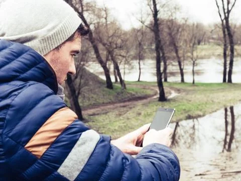 Young man using cell phone in park Stock Photos
