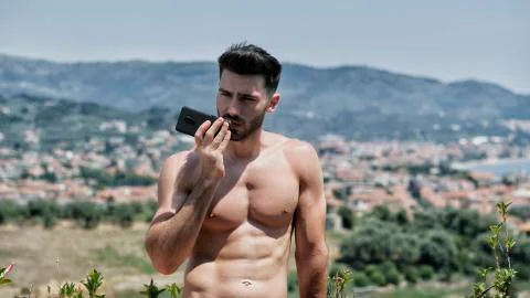 Young man using cell phone to send voice message Stock Photos