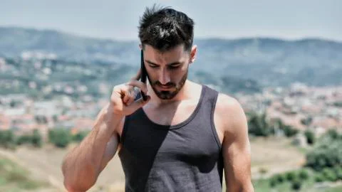 Young man using cell phone to call someone Stock Photos
