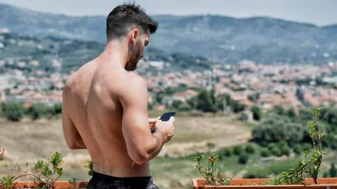 Young man using cell phone to send message Stock Photos