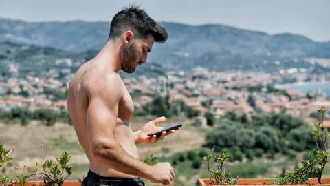 Young man using cell phone to send message Stock Photos