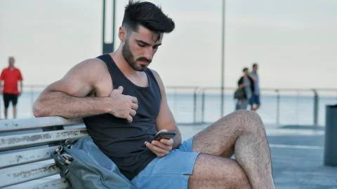 Young man using cell phone to send message Stock Photos