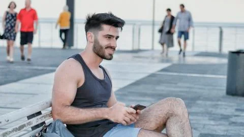 Young man using cell phone to send message Stock Photos
