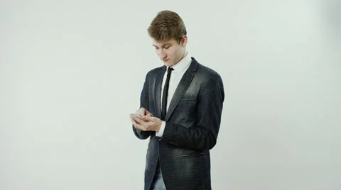 Young man is using a cellphone Stock Footage 62900572