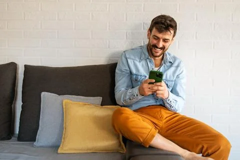 Young man using cellphone for work, social media or relaxation. Smart phone.. Stock Photos