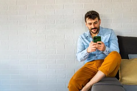 Young man using cellphone for work, social media or relaxation. Smart phone.. Stock Photos