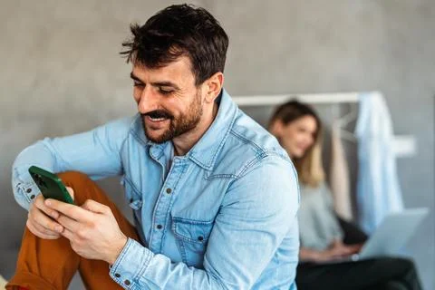 Young man using cellphone for work, social media or relaxation. Smart phone.. Stock Photos