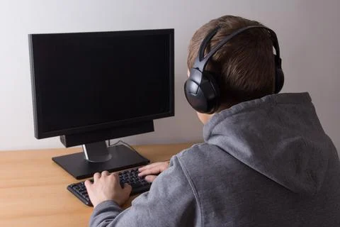 Young man using a computer and listening music Stock Photos