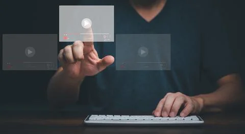 Young man using computer and touching on virtual screen online streaming vide Stock Photos
