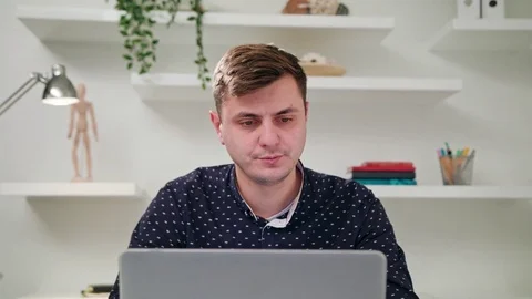 A Young Man Using a Computer Indoors Stock Footage 83833590