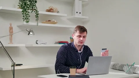 A Young Man Using a Computer Indoors Stock Footage 83836986