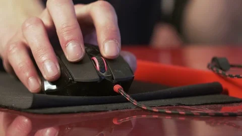 Young man using computer mouse sitting by the table at home Stock Footage 74976852