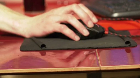 Young man using computer mouse sitting by the table at home Stock Footage 74988886