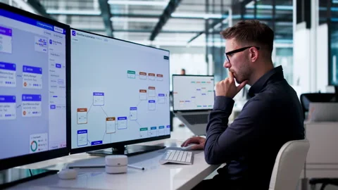 Young Man Using Computer To Optimize Business Workflow Stock Footage 342960241