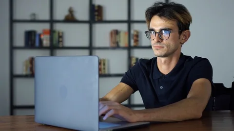 Young Man Using Computer for Trading, earning money online, Freelancer, Working Stock Footage 93275748