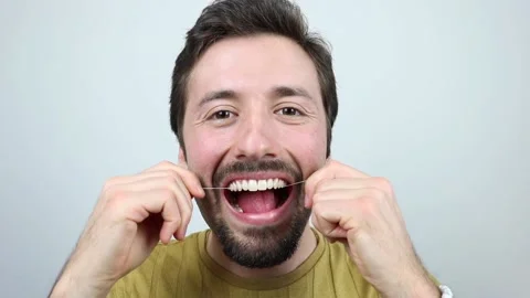 Young man using dental floss Stock Footage 164093215