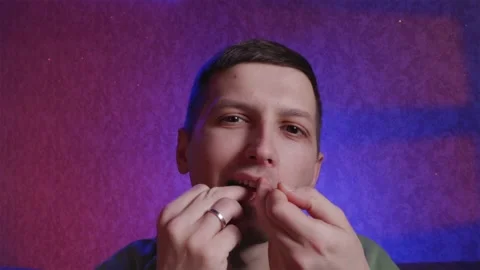 Young man using dental floss for oral hygiene routine Stock Footage 333757147