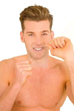 Young man using dental floss Stock Photos