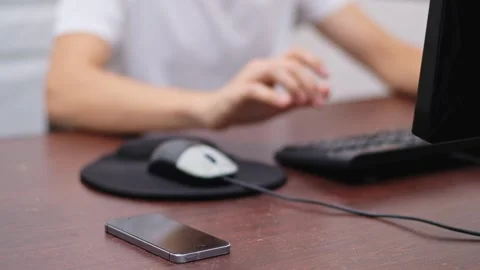 Young man using desktop computer ignores smartphone notification for produc.. Stock Footage 339448562