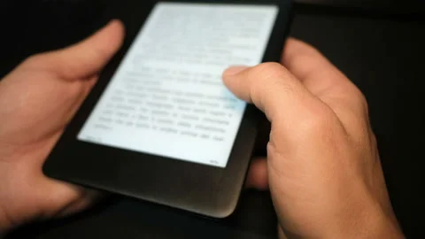 Young man using digital ebook reader at home,new book reading technology Stock Footage 143593653